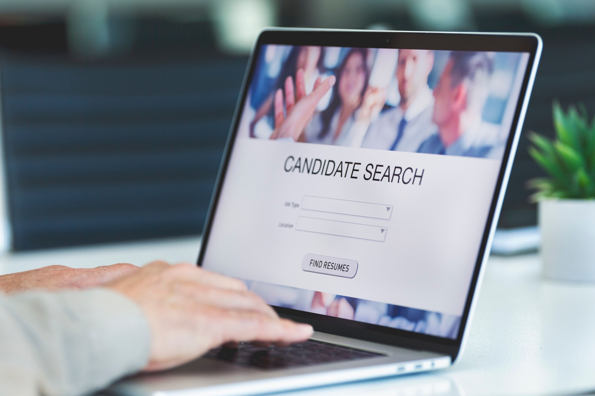 Businessman looking at recruitment website on a laptop computer.